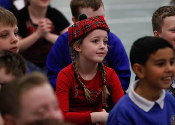 A pupil at Kilsyth Primary School enjoys a Burns-themed assembly. PIC Scott Louden/JP.