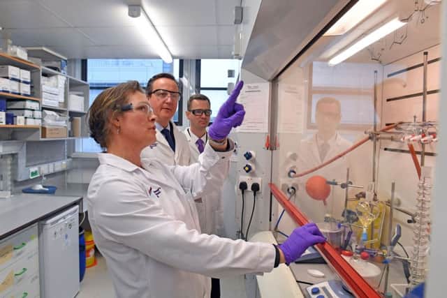David Cameron speaks with Associate Chemist Helen Boffey (front) during a tour of the Cambridge Drug Discovery Institute Picture: Victoria Jones/PA Wire