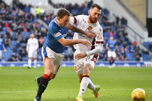 Lee Hodson battles for possession with Motherwell's Joe Chalmers during Saturday's 2-1 victory for the Ibrox club. Picture: SNS