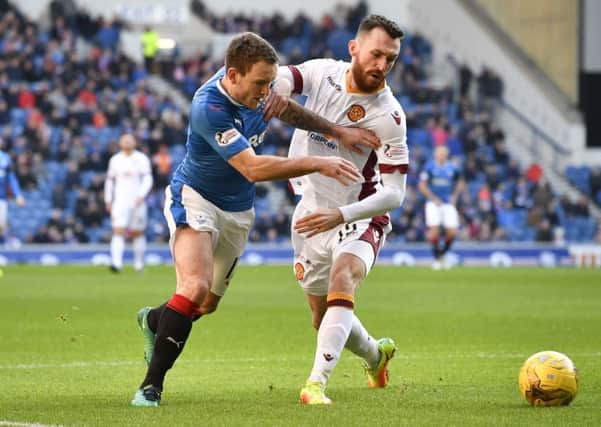 Lee Hodson battles for possession with Motherwell's Joe Chalmers during Saturday's 2-1 victory for the Ibrox club. Picture: SNS
