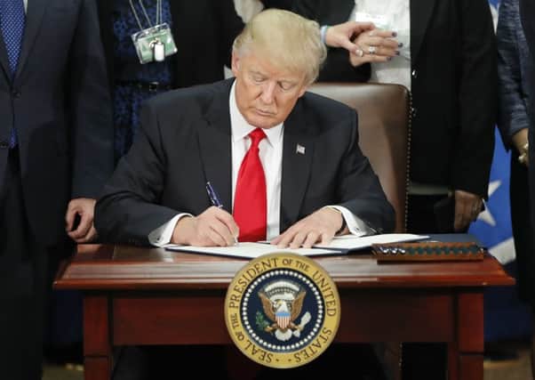 President Trump signs an executive order for border security and immigration enforcement improvements. Picture: AP
