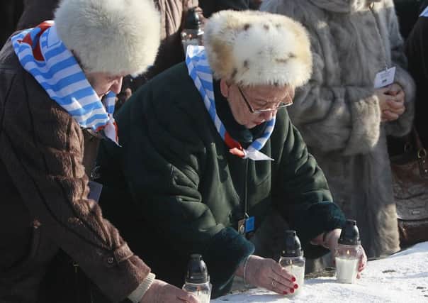 Holocaust survivors light candles at the Auswitz International Monument to the Victims of Fascism. Picture: AP