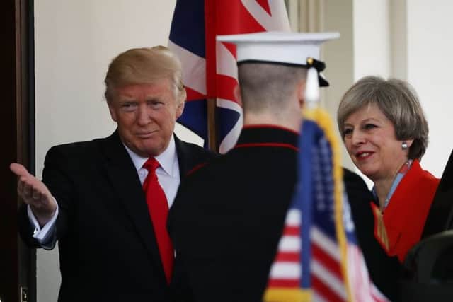 Donald Trump greets Theresa May upon her arrival to the White House.  (Photo by Mark Wilson/Getty Images)