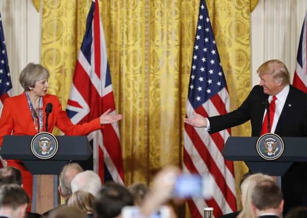 President Donald Trump and Theresa May gesture during their joint news conference last week in the East Room of the White House. Picture: AP Photo/Pablo Martinez Monsivais
