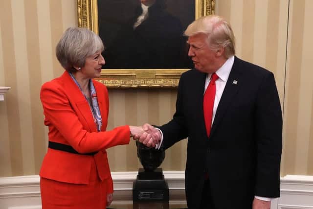 British Prime Minister Theresa May shakes hands with U.S. President Donald Trump (Photo by Christopher Furlong/Getty Images)