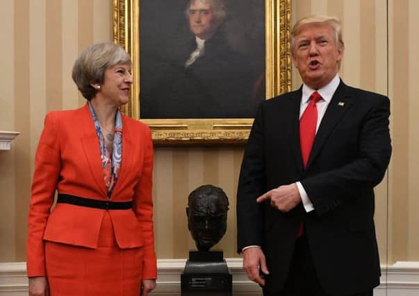 Prime Minister Theresa May meets US President Donald Trump by a bust of Sir Winston Churchill in the Oval Office.