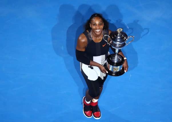 Serena Williams poses with the Daphne Akhurst Trophy after defeating older sister Venus to win the Australian Open.  Picture: Cameron Spencer/Getty Images