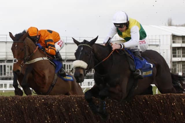 Many Clouds and Leighton Aspell (right) jump an early fence in company with Thistlecrack ridden by Tom Scudamore before going on to win the Betbright Trial Cotswold Chase Race at Cheltenham. The winner collapsed and died after the race. Picture: Julian Herbert/PA Wire