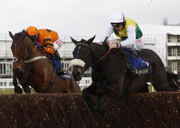Many Clouds and Leighton Aspell (right) jump an early fence in company with Thistlecrack ridden by Tom Scudamore before going on to win the Betbright Trial Cotswold Chase Race at Cheltenham. The winner collapsed and died after the race. Picture: Julian Herbert/PA Wire