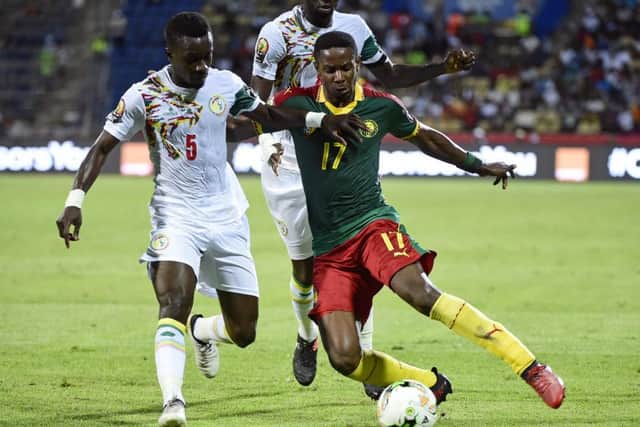 Cameroon's Hearts midfielder Arnaud Djoum, right, challenges Senegal midfielder Idrissa Gana Gueye. Picture: AFP/Getty Images