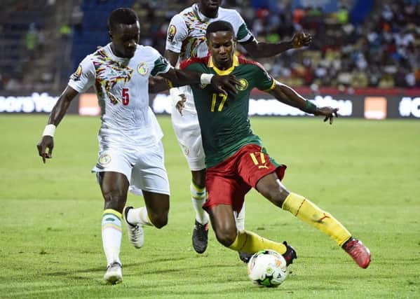 Cameroon's Hearts midfielder Arnaud Djoum, right, challenges Senegal midfielder Idrissa Gana Gueye. Picture: AFP/Getty Images