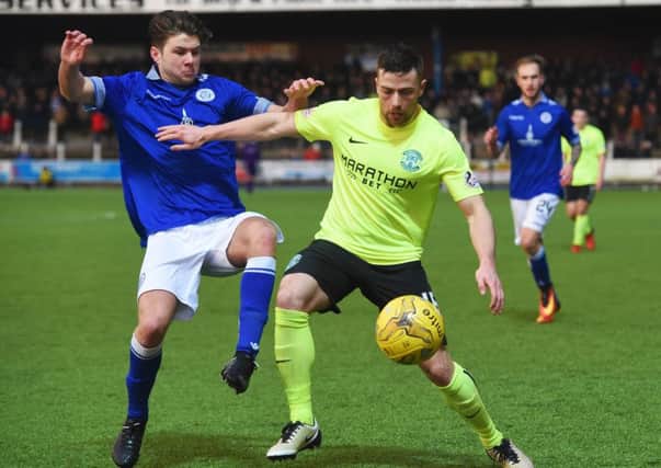 Hibs defender Lewis Stevenson resists  the challenge of Queens' Dom Thomas. Picture: SNS.