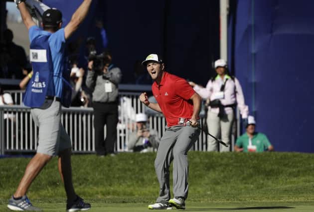 John Rahm celebrates after making an eagle at the 72nd hole at Torrey Pines in winning the Farmers Insurance Open. Picture: AP