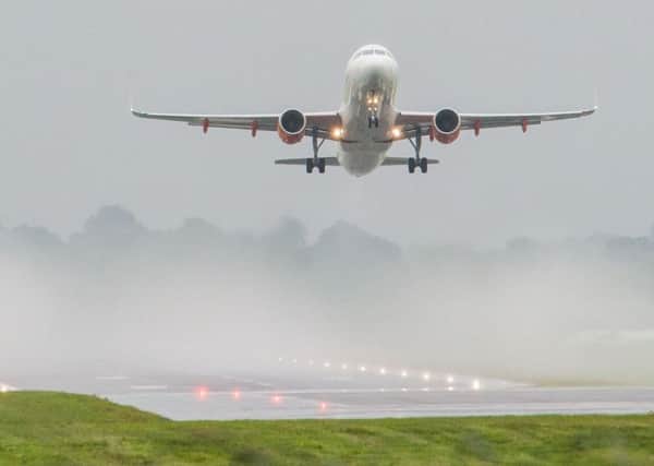A plane lands at Edinburgh Airport. Picture: Ian Georgeson