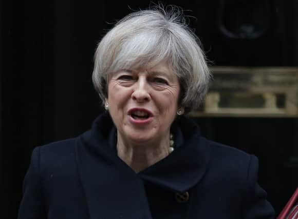 CORRECTION - British Prime Minister Theresa May leaves 10 Downing street for the weekly Prime Minister's Questions session at the House of Commons in central London on February 1, 2017. 
British MPs are expected today to approve the first stage of a bill empowering Prime Minister Theresa May to start pulling Britain out of the European Union. / AFP PHOTO / Daniel LEAL-OLIVAS / Correcting Date
The erroneous mention[s] appearing in the metadata of this photo by Daniel LEAL-OLIVAS has been modified in AFP systems in the following manner: [February 1, 2017] instead of [February 2, 2017]. Please immediately remove the erroneous mention[s] from all your online services and delete it (them) from your servers. If you have been authorized by AFP to distribute it (them) to third parties, please ensure that the same actions are carried out by them. Failure to promptly comply with these instructions will entail liability on your part for any continued or post notification usage. Therefore we thank you very much for all y