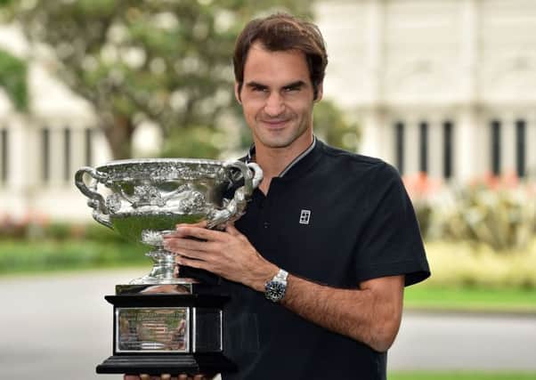 Roger Federer with the championship trophy the day after winning the Australian Open men's singles final for his 18th career grand slam in Melbourne. Picture: Saeed Khan/AFP/Getty Images