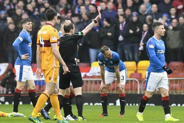 Rangers' Michael O'Halloran (right) received a straight red card for a tackle on Motherwell's Carl McHugh. Picture: SNS