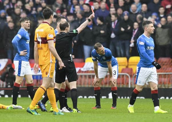 Rangers' Michael O'Halloran (right) received a straight red card for a tackle on Motherwell's Carl McHugh. Picture: SNS