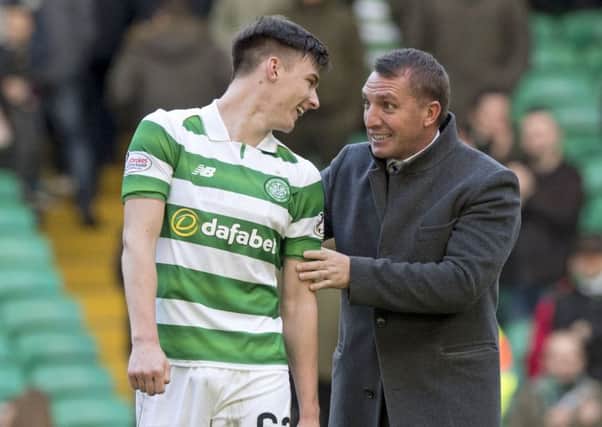 Celtic manager Brendan Rodgers embraces Kieran Tierney after their 4-0 win over Hearts that broke the Lison Lions' unbeaten record.