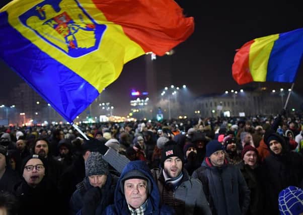 A protest in front of the government headquarters in Bucharest against controversial decrees to pardon corrupt politicians and decriminalise other offences. Picture: AFP/Getty Images