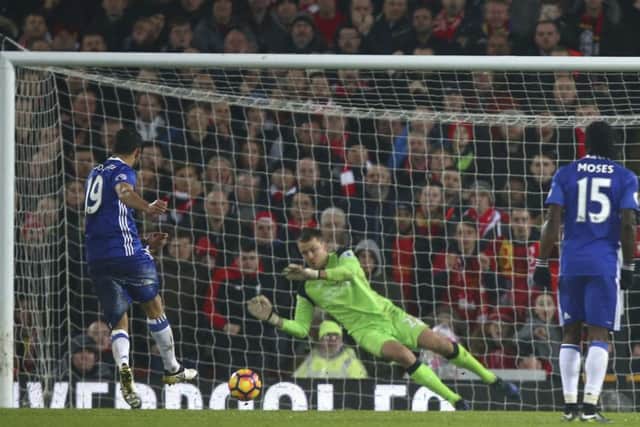 Chelsea's Diego Costa, left, sees his penalty saved by Liverpool goalkeeper Simon Mignolet at Anfield. Picture: AP Photo/Dave Thompson