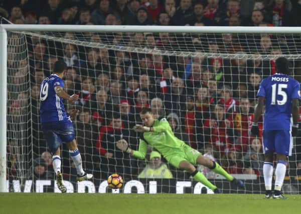Chelsea's Diego Costa, left, sees his penalty saved by Liverpool goalkeeper Simon Mignolet at Anfield. Picture: AP Photo/Dave Thompson