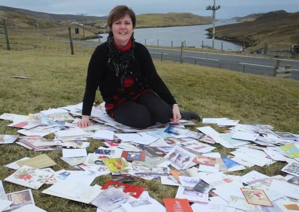 Sharon Deyell, from Bixter, Shetland, with some of the thousands of Christmas cards donated to the Woodland Trust charity to be recycled to help plant trees across the UK