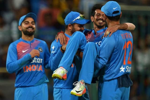 Indian bowler Yazvendra Chahal is lifted up by his jubilant team-mates after his six-wicket haul against England in Bangalore. Picture: Manjunath Kiran/AFP/Getty Images