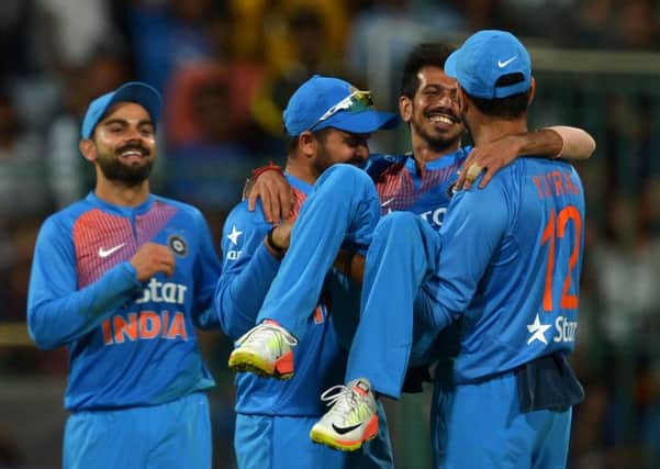 Indian bowler Yazvendra Chahal is lifted up by his jubilant team-mates after his six-wicket haul against England in Bangalore. Picture: Manjunath Kiran/AFP/Getty Images