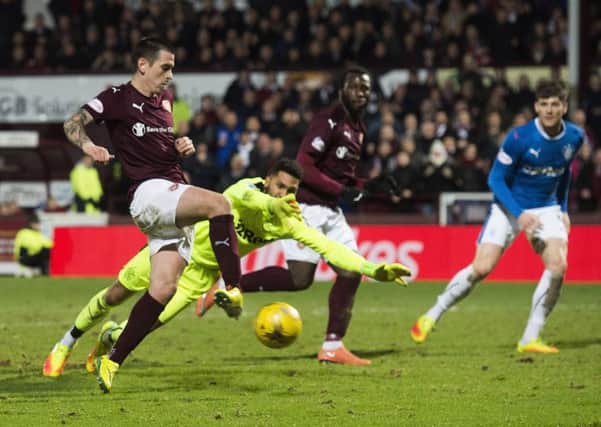 Jamie Walker slides into an empty net to put Hearts 4-1 up against Rangers. Picture: SNS