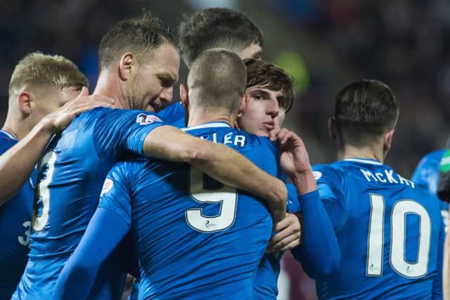 Emerson Hyndman (centre) is mobbed by his Rangers' team-mates after scoring the equaliser. Picture: SNS