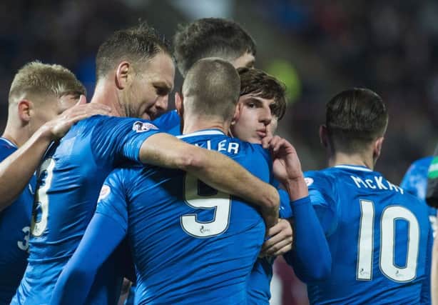 Emerson Hyndman (centre) is mobbed by his Rangers' team-mates after scoring the equaliser. Picture: SNS