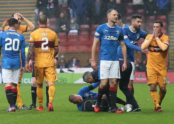 Scott McDonald, far right, is stunned after being shown a straight red card for a challenge on Kenny Miller. Picture: PA