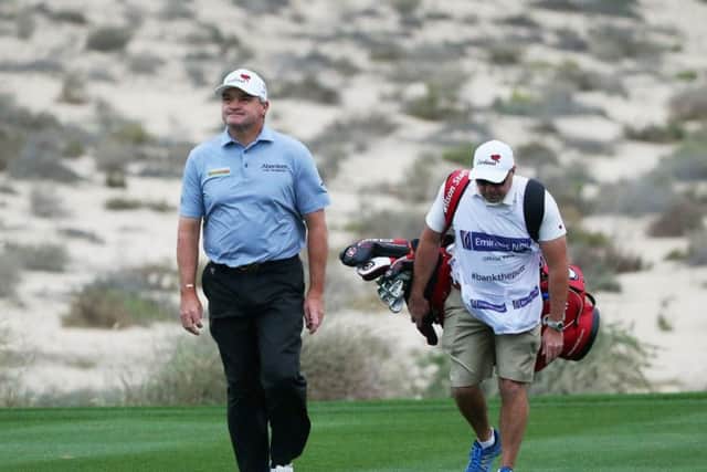 Paul Lawrie and his caddie Davy Kenny out on the Emirates Golf Club during the first round of the Omega Dubai Desert Classic. Picture: Getty Images