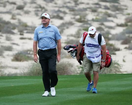 Paul Lawrie and his caddie Davy Kenny out on the Emirates Golf Club during the first round of the Omega Dubai Desert Classic. Picture: Getty Images