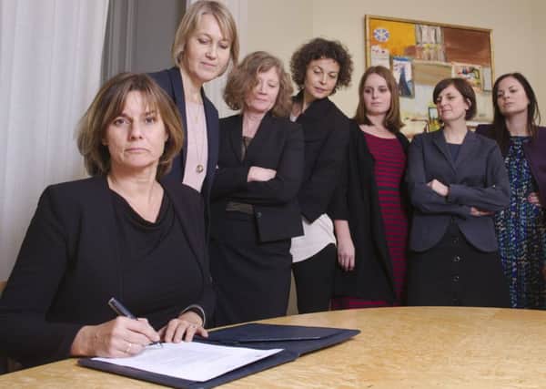 Isabella Lovin, left, signs a proposal for Swedens new climate law in an all-woman photo in a swipe at Trump . Picture: AP