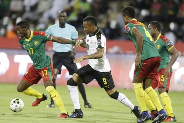 Arnaud Djoum skips away from Ghanas Jordan Ayew in the semi-final. Picture: Sunday Alamba