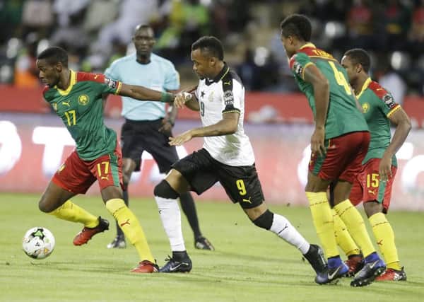 Arnaud Djoum skips away from Ghanas Jordan Ayew in the semi-final. Picture: Sunday Alamba