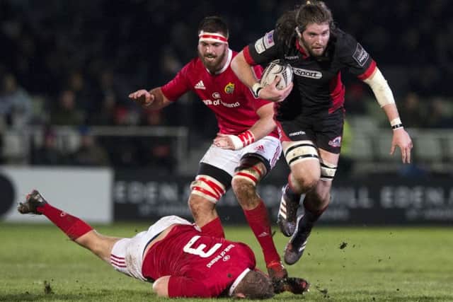 Edinburgh's Ben Toolis breaks away from Munster's Stephen Archer. Picture: Paul Devlin/SNS