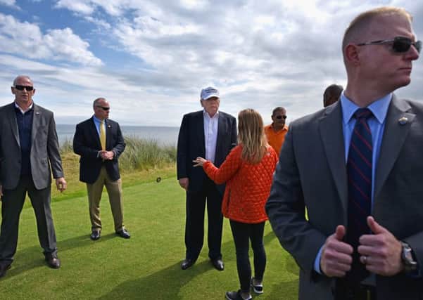 Donald Trump surrounded by bodyguards at Trump International Golf Links in Aberdeenshire. Picture: Jeff J Mitchell/Getty