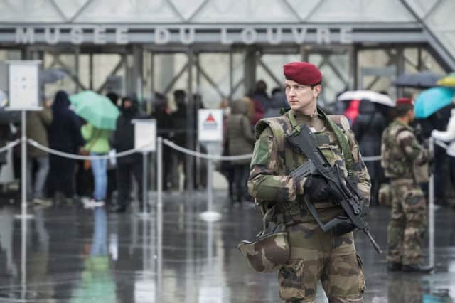 A French soldier patrols in the courtyard of the Louvre museum with the visitor control in background in Paris. Picture; AP