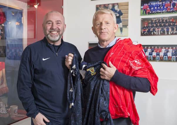 Scotland manager Gordon Strachan gives Spartans chief executive Douglas Samuel memorabilia from his successful playing career. Photograph: Jeff Holmes