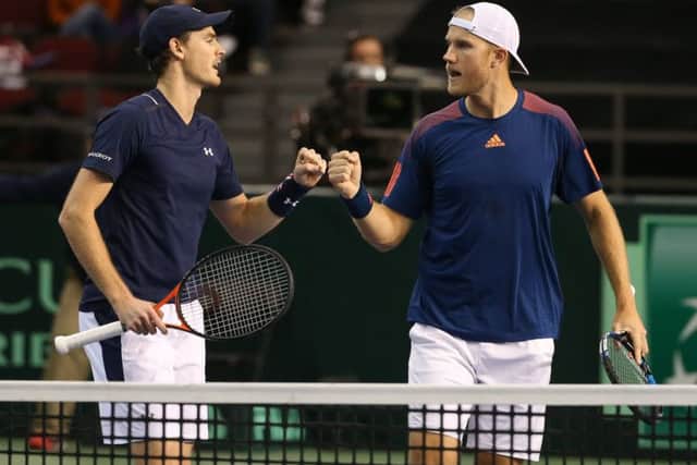 Jamie Murray, left, and Dom Inglot fist-bump after winning a set point against Vasek Pospisil and Daniel Nestor. Photograph: Andre Ringuette/Getty
