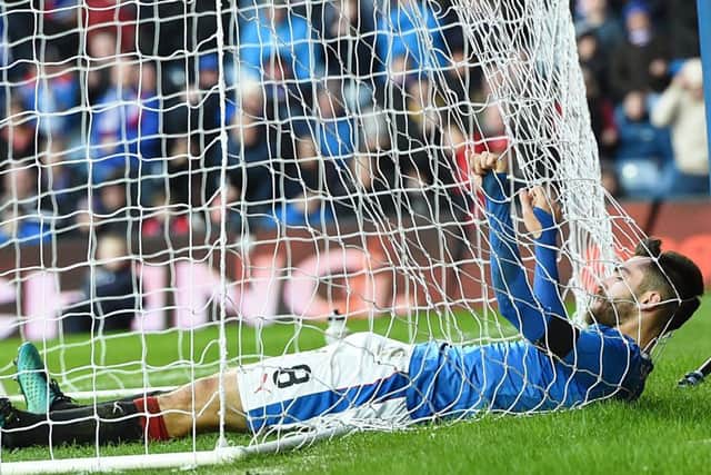 Rangers midfielder Jon Toral gets tangled in the net at Ibrox. Picture: SNS.