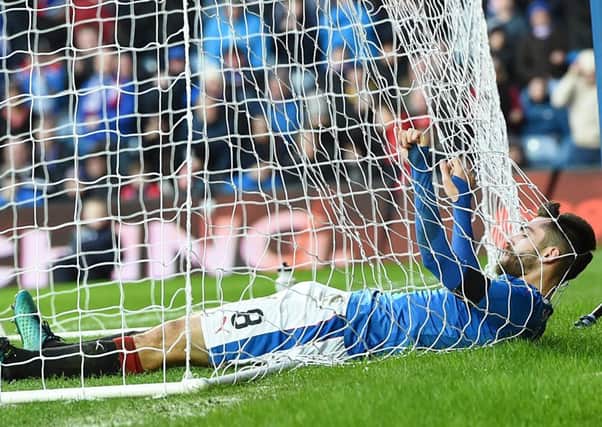 Rangers midfielder Jon Toral gets tangled in the net at Ibrox. Picture: SNS.