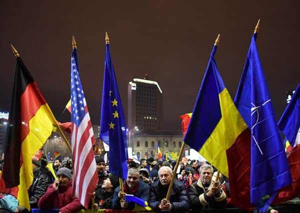 Crowds in front of the government headquarters in Bucharest protest against the governments contentious corruption decree. Picture: Getty
