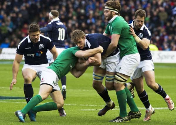 Scotland's Jonny Gray  weathers an Irish tackle. Picture: SNS