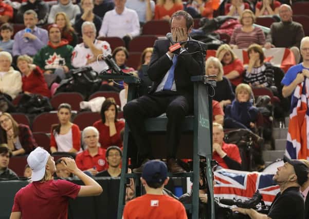 Denis Shapovalov tries to apologise to umpire Arnaud Gabas after he hit the official in the eye with a ball in Canada's Davis Cup tie with Great Britain. Pic: Getty