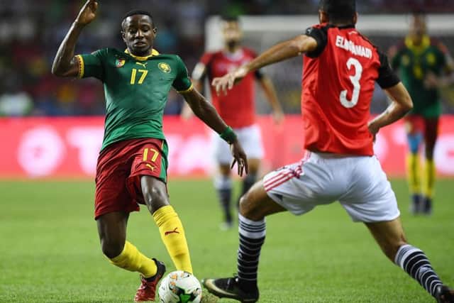 Arnaud Djoum takes on Egypts Ahmed Elmohamady. Picture: AFP/Getty.