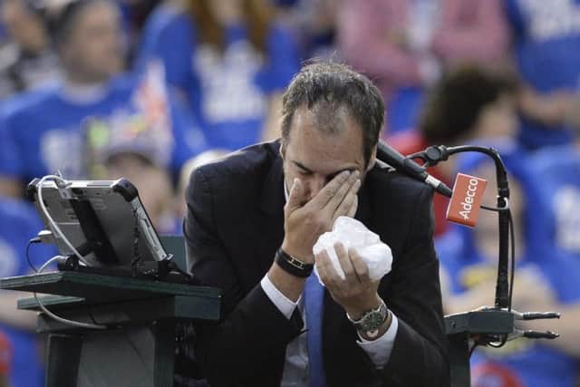 French umpire Arnaud Gabas holds his face after being struck by a ball hit by Denis Shapovalov. Picture: AP.